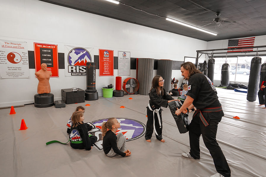 Rise Martial Arts students training with an instructor in the Spanish Fork dojo